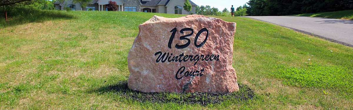 Large boulder engraved with 130 Wintergreen Court